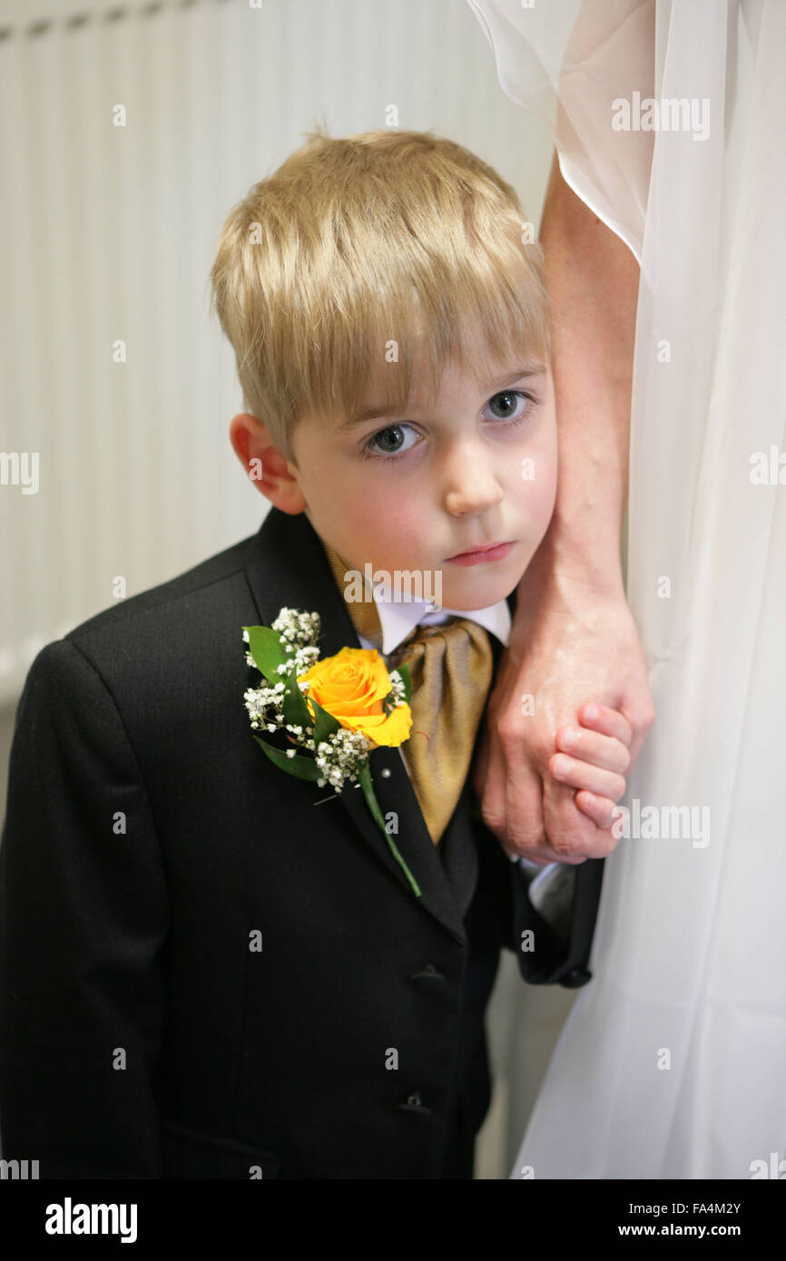 Pageboy holding the hand of the bride at a registry office wedding
