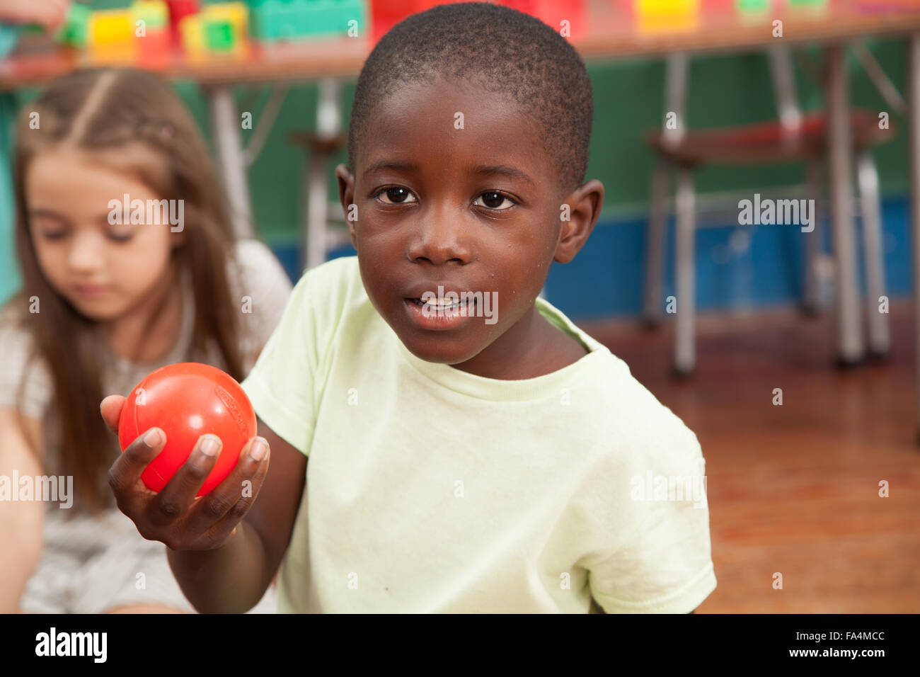 African boy showing a red ball Stock Photo Alamy