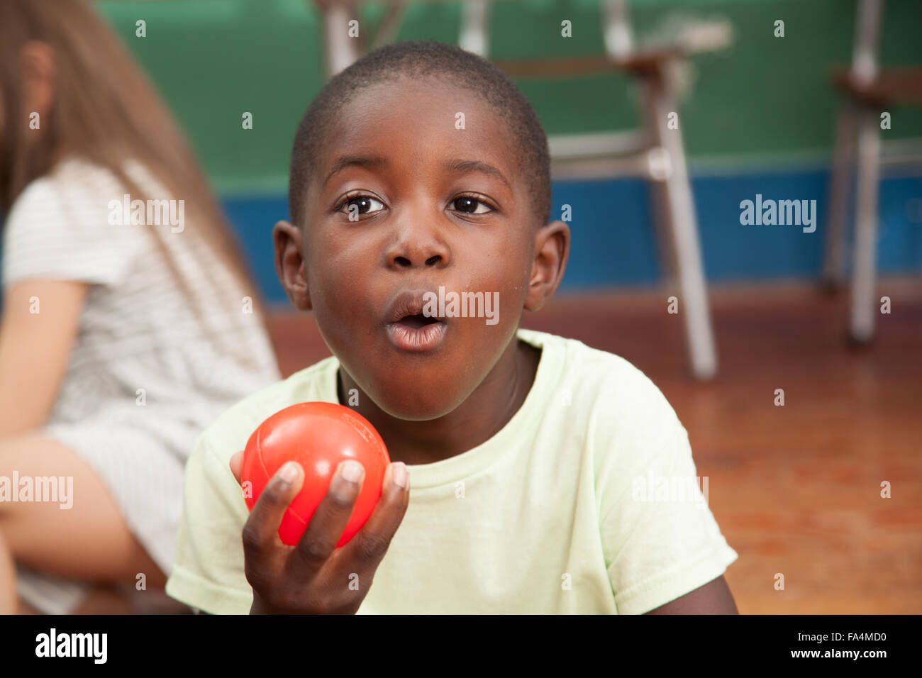 African boy showing a red ball Stock Photo Alamy