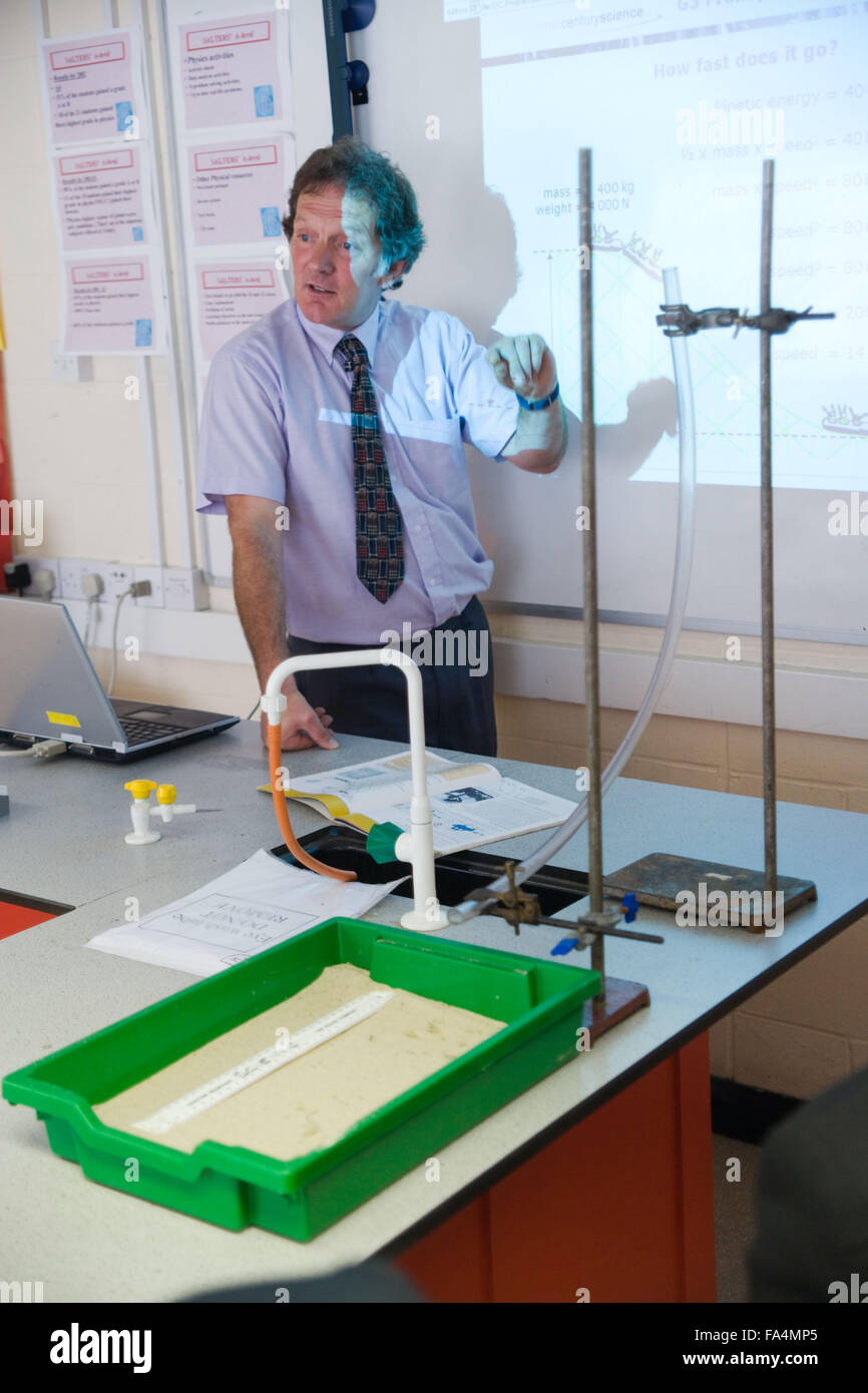 Secondary School Science teacher using whiteboard to explain to