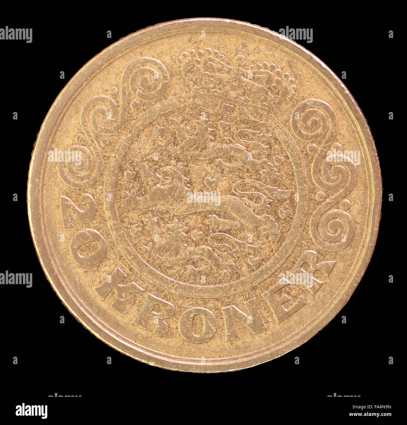 The tail face of 20 krone coin, issued by Denmark in 1991, depicting the national coat of arms. Image isolated on black backgrou Stock Photo