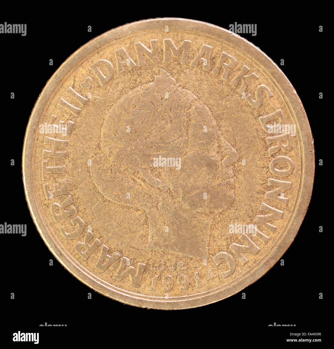 The head face of 20 krone coin, issued by Denmark in 1991, depicting a portrait of Queen Margrethe II. Image isolated on black b Stock Photo