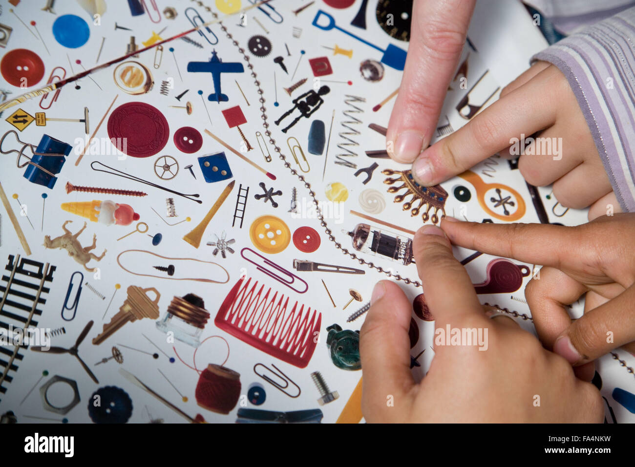 Children pointing to picture of crown on sheet of objects Stock Photo ...