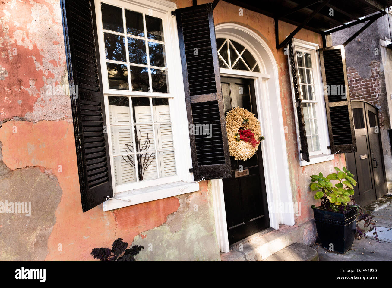 Door on a traditional home along Church Street decorated with a christmas wreath for the holiday season in Charleston, SC. Stock Photo