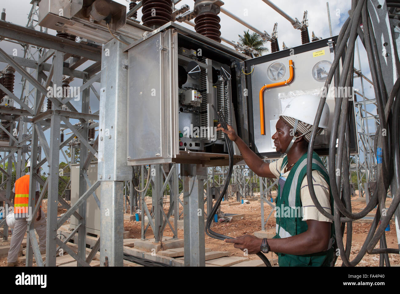 An electrical engineer maintains equipment at Mtoni Service Station in