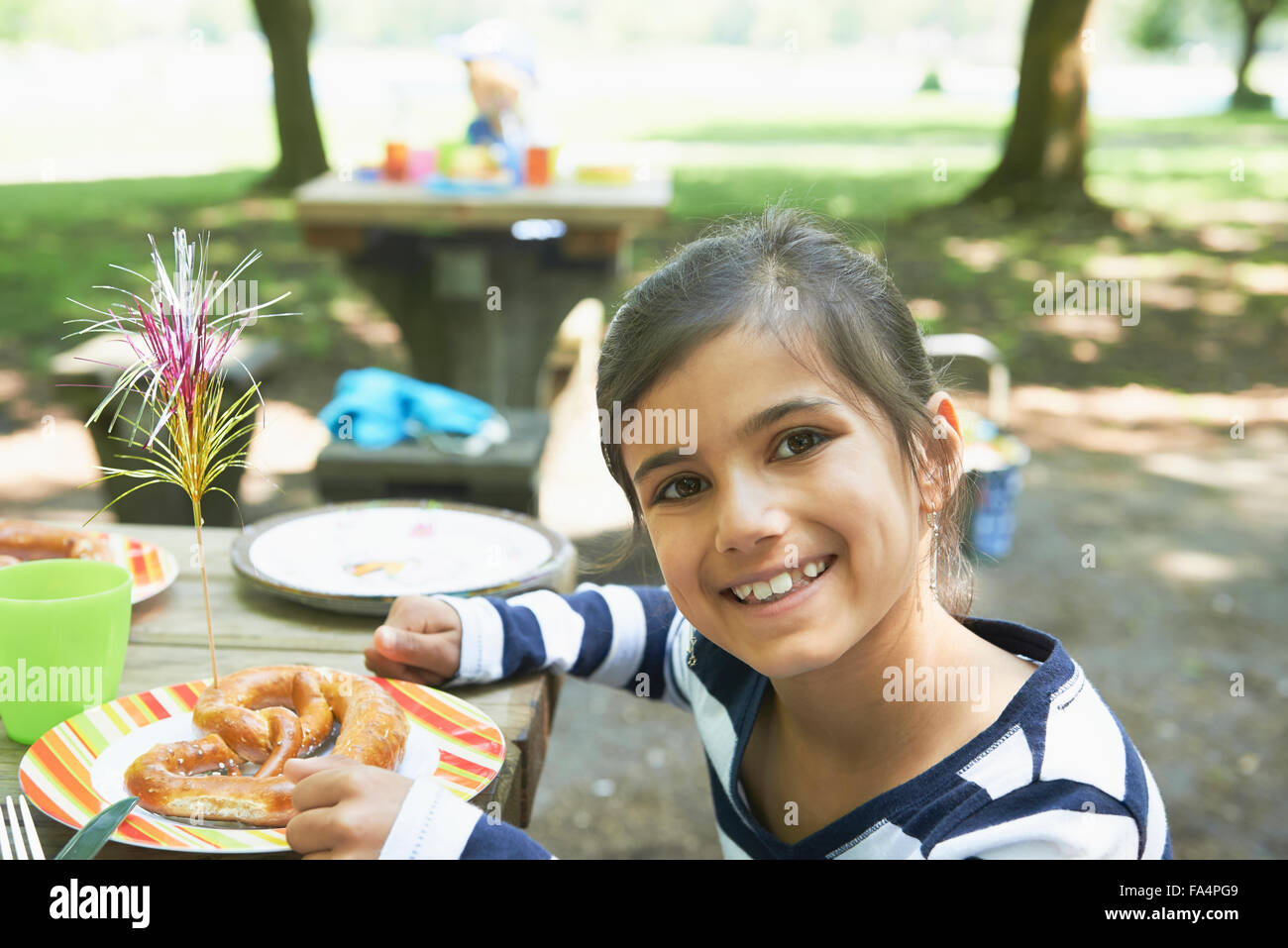 Portrait of a girl eating food at picnic, Munich, Bavaria, Germany Stock Photo