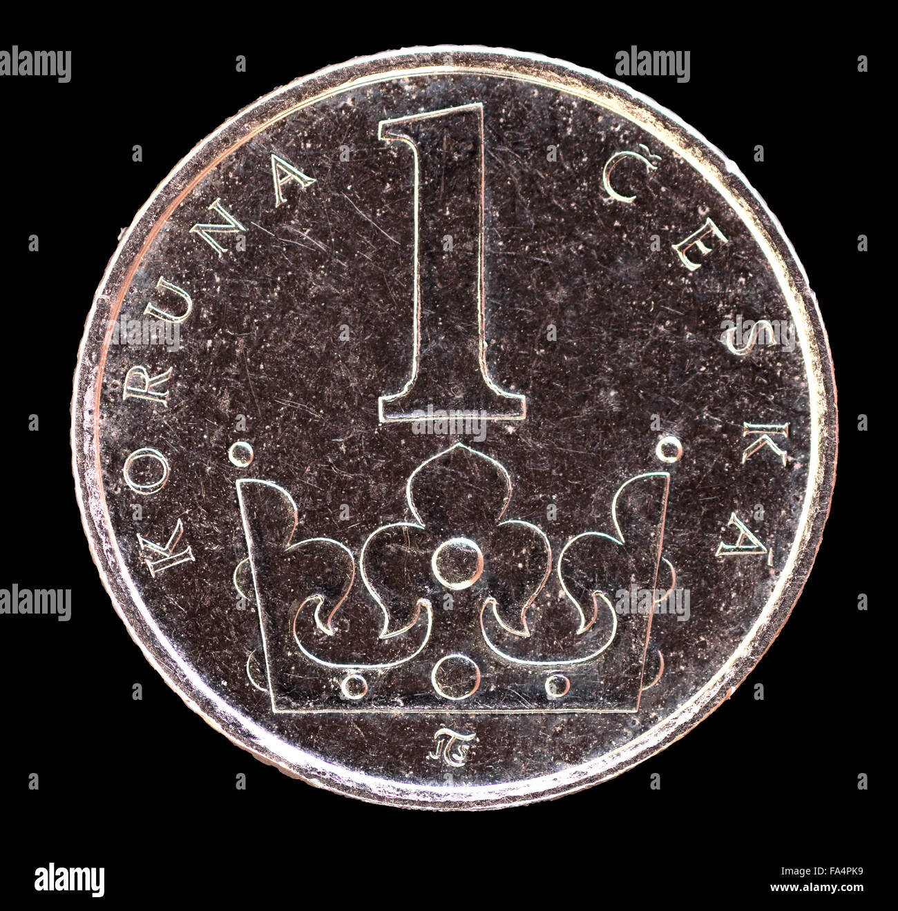 The tail face of one koruna coin, issued by Czech Republic in 2009, depicting a crown. Image isolated on black background Stock Photo