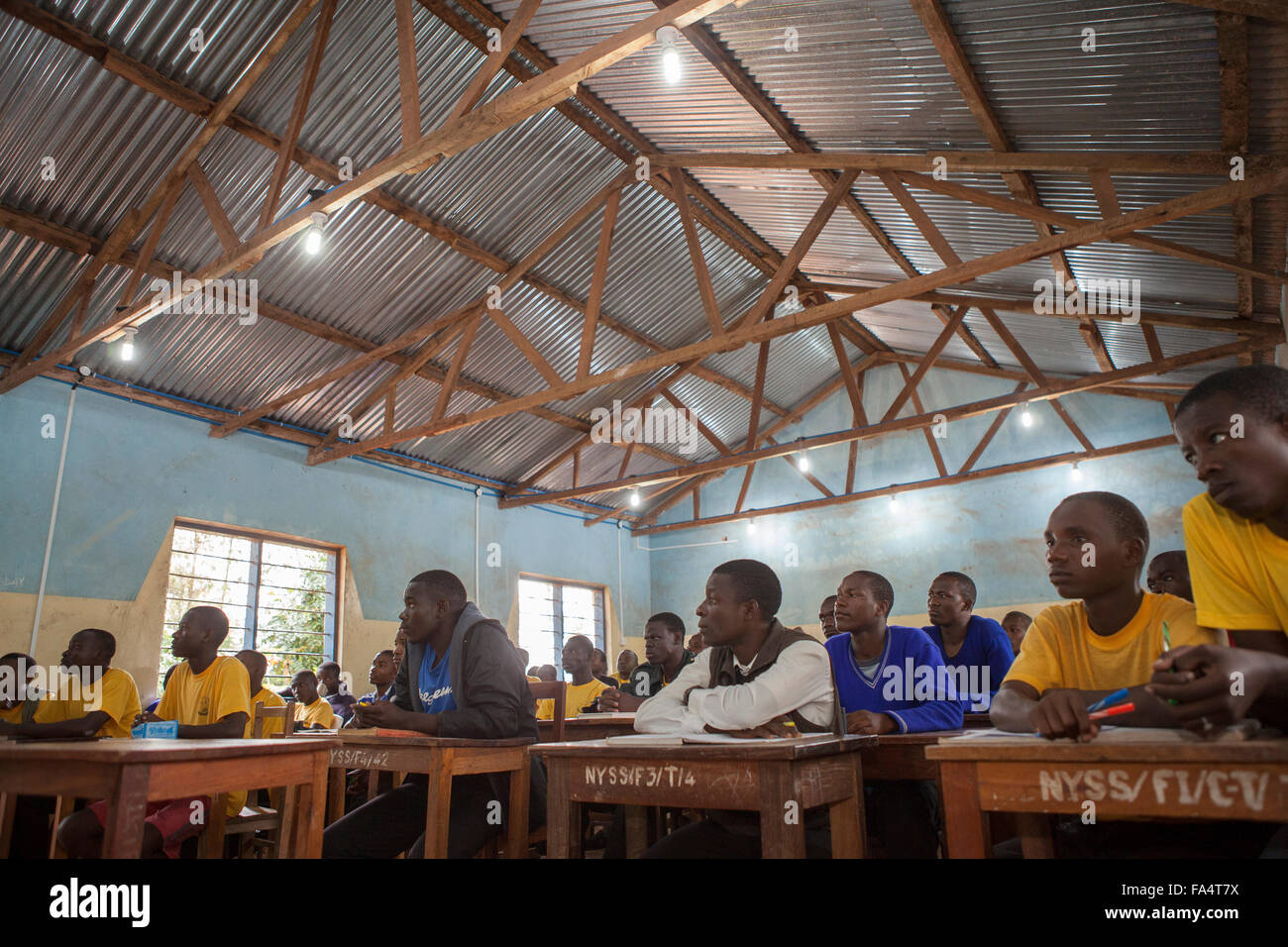 Students attend school in a classroom lit by solar power in Nyarubanda village, Kigoma Region, Western Tanzania. Stock Photo