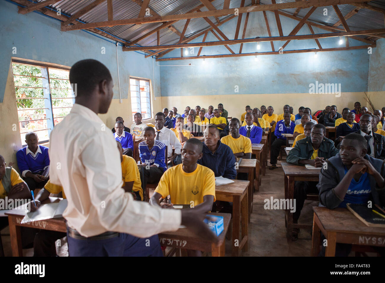 Students attend school in a classroom lit by solar power in Nyarubanda village, Kigoma Region, Western Tanzania. Stock Photo