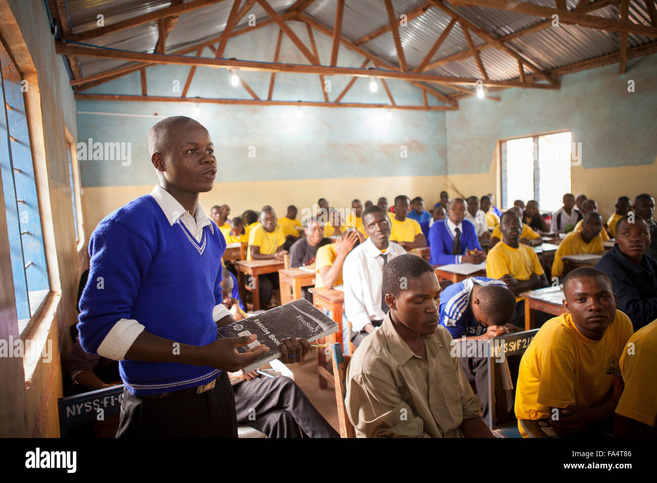 Students attend school in a classroom lit by solar power in Nyarubanda village, Kigoma Region, Western Tanzania. Stock Photo
