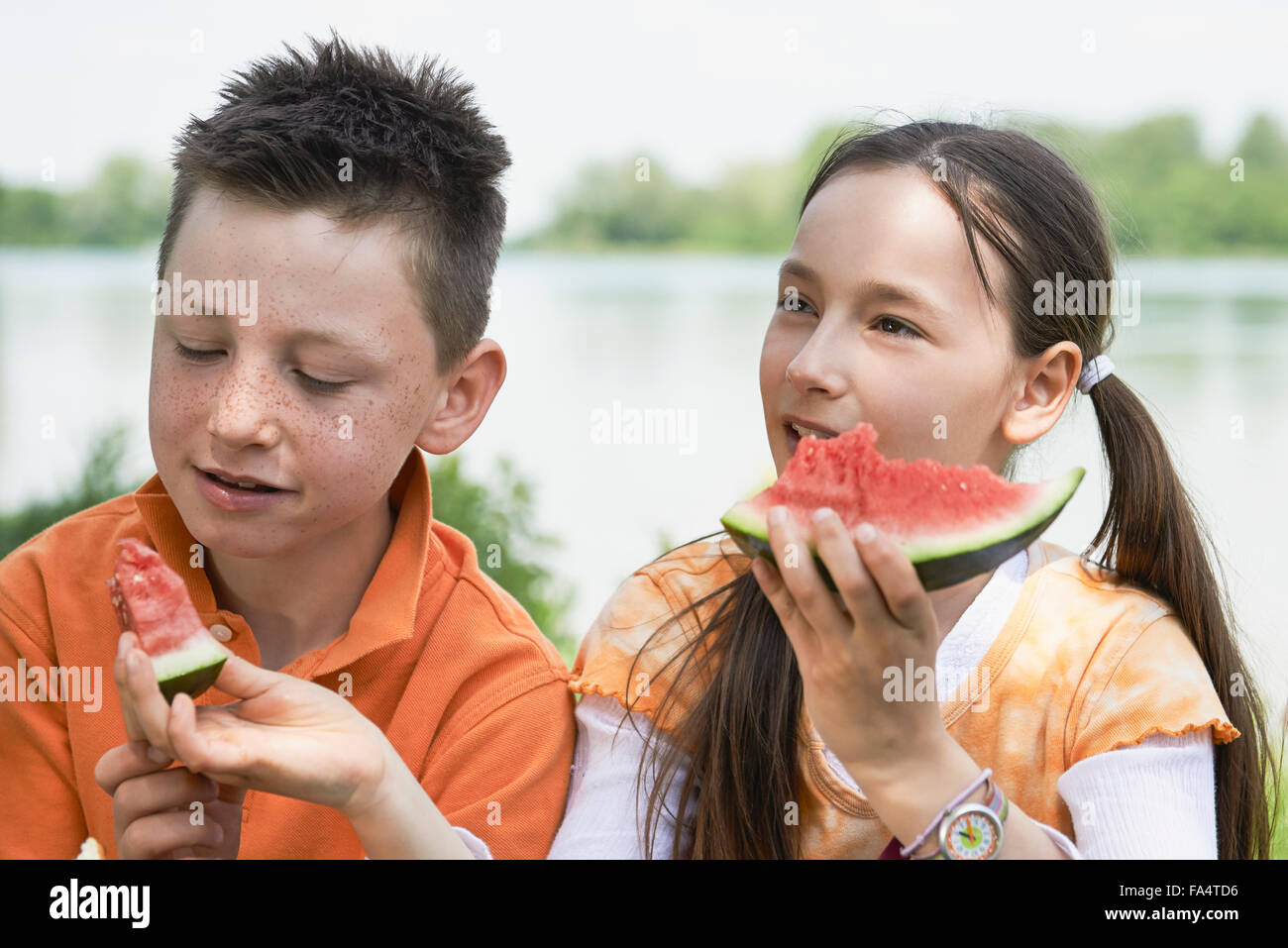 Children enjoying slices of watermelon at picnic, Munich, Bavaria, Germany Stock Photo