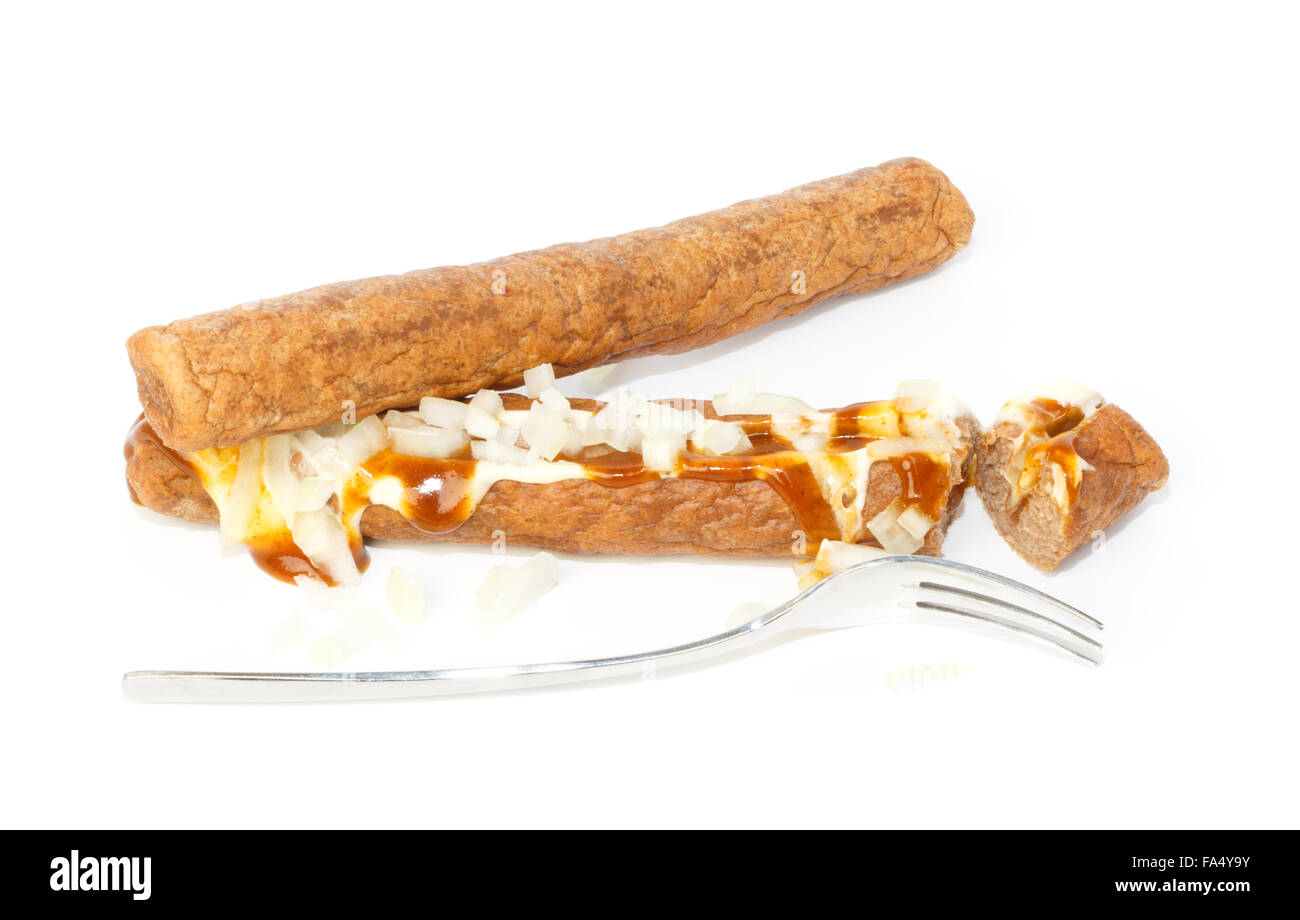 Two frikandellen speciaal, one cut with a little fork. It's a Dutch fast food snack, with mayonnaise, curry sauce and chopped on Stock Photo