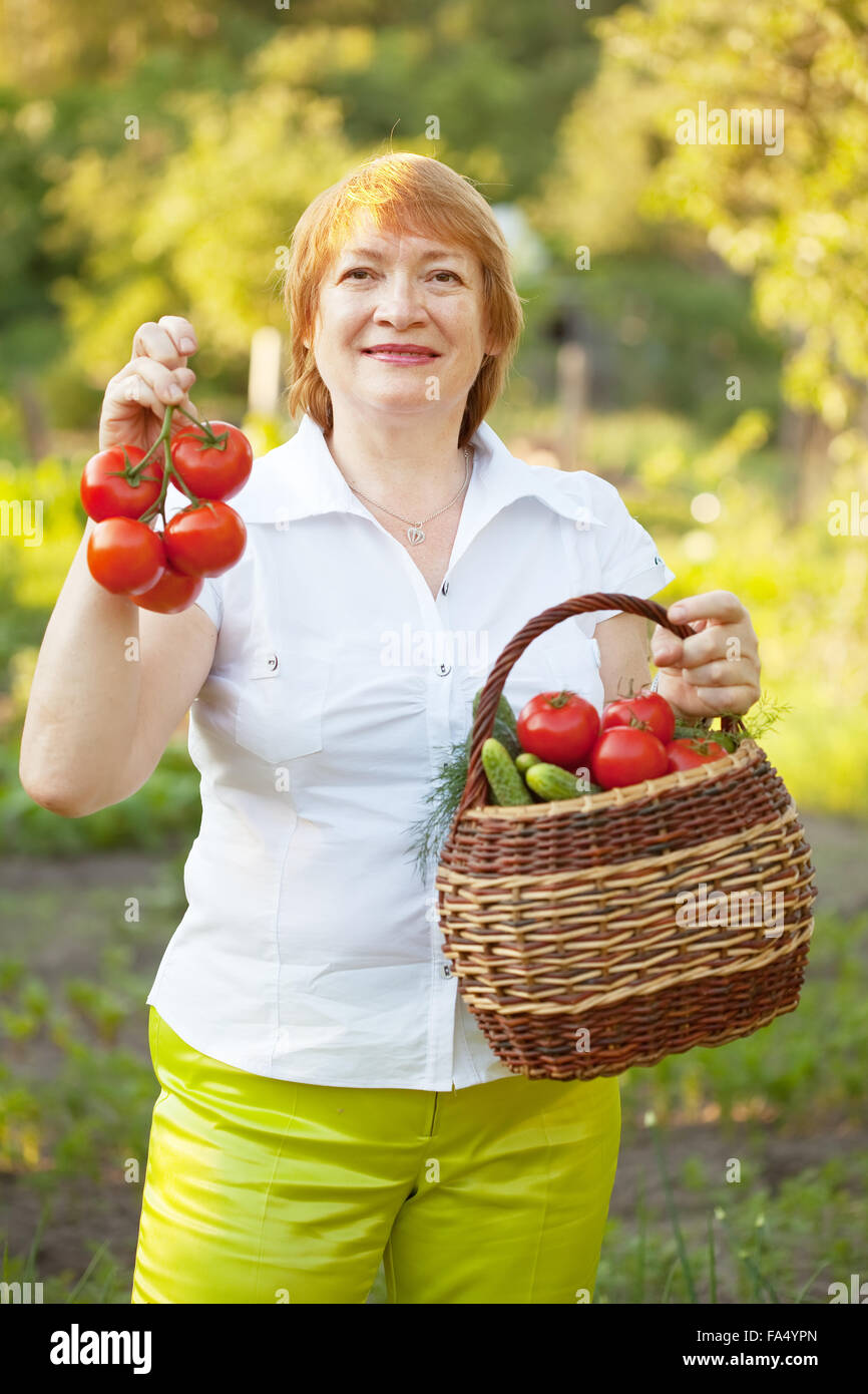 Happy mature woman with vegetables harvest Stock Photo - Alamy