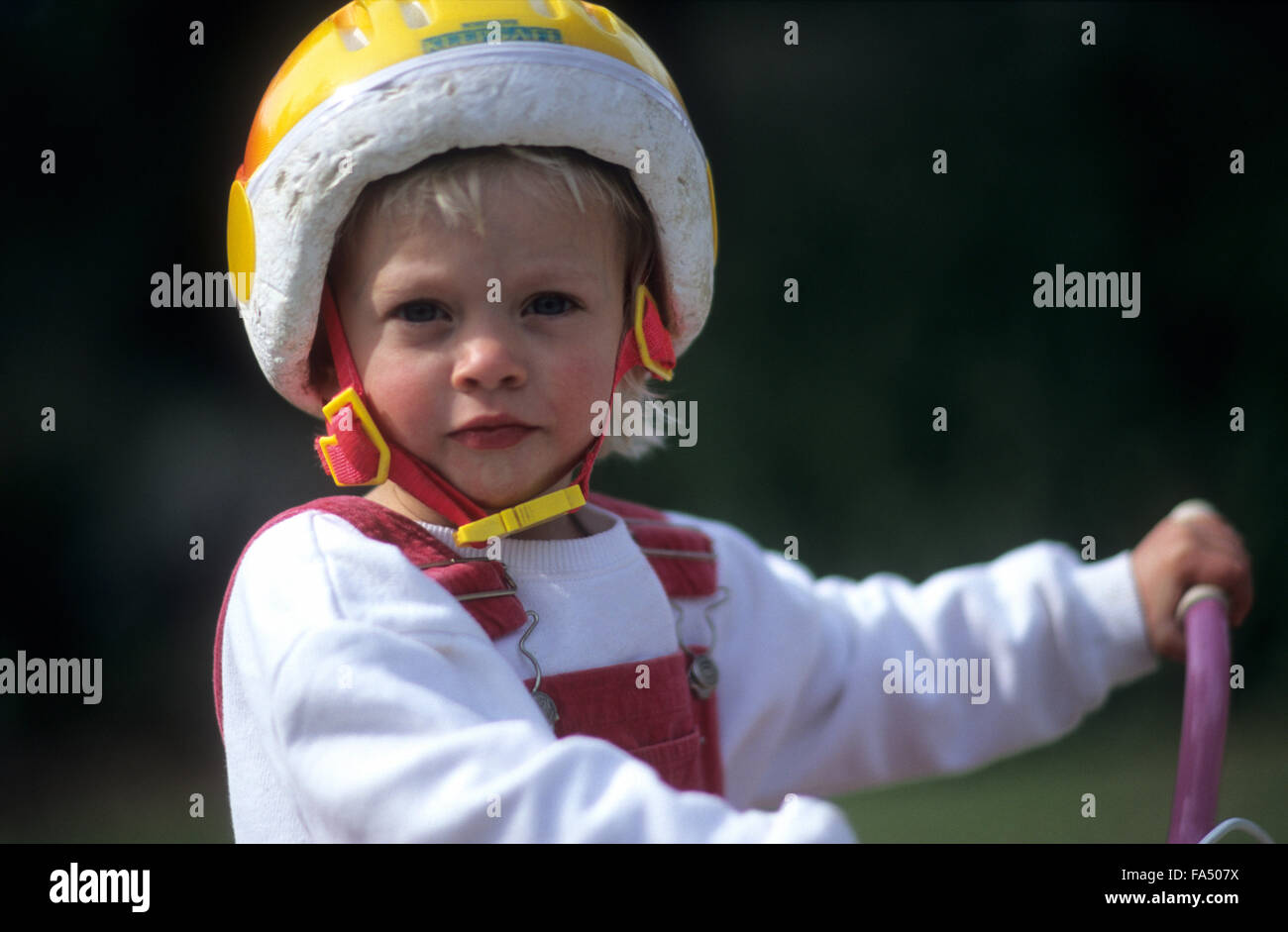 Child, age 3 years on bicycle with cycle helmet Stock Photo Alamy