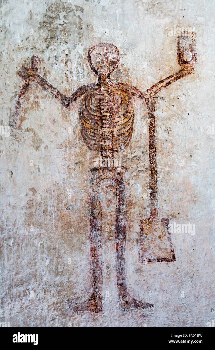 Figure of Doom skeleton with a scythe, hourglass and spade on the west wall of Partrishow church of St Islow, Stock Photo