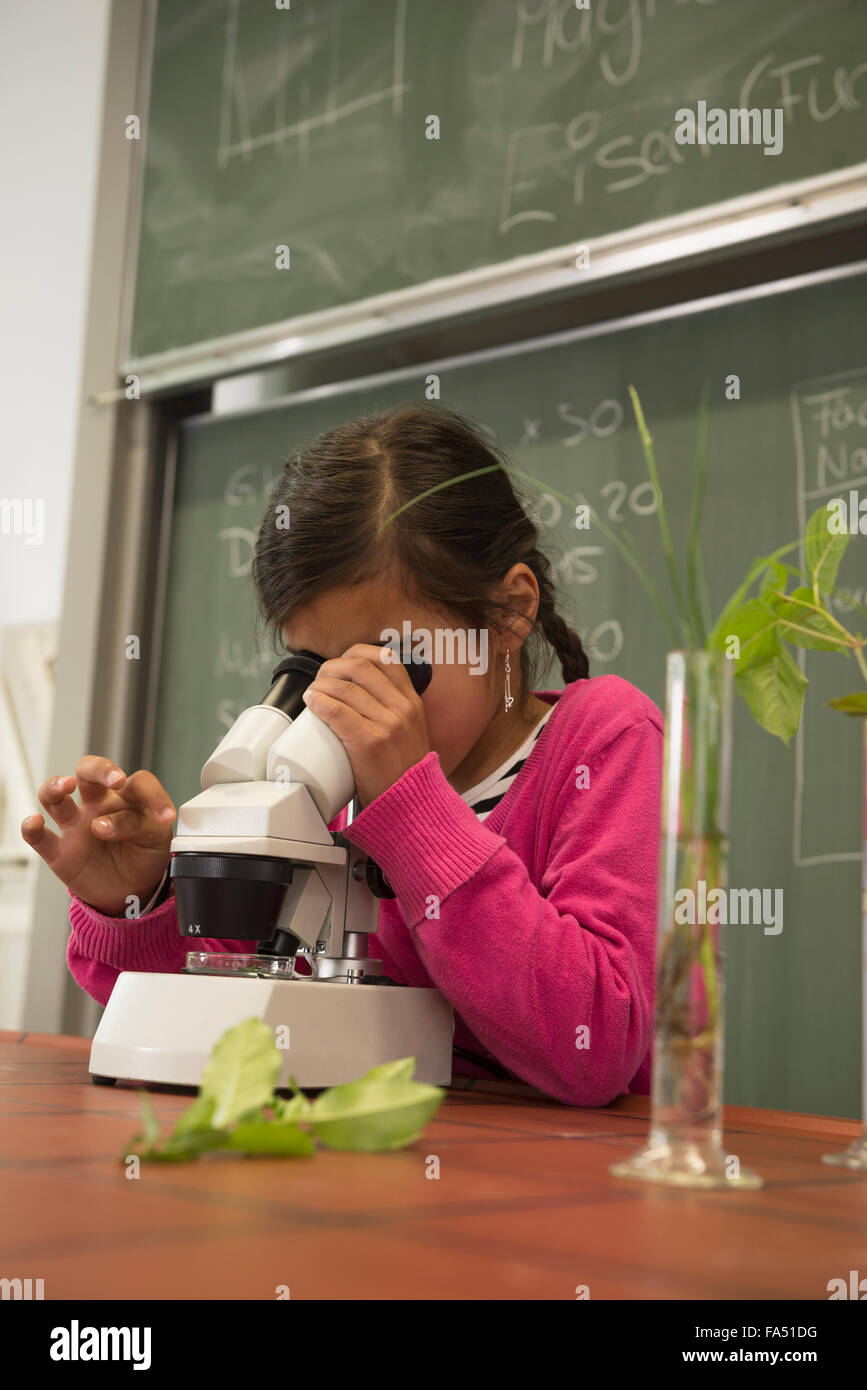 Female student in biological classroom with science microscope hi-res ...