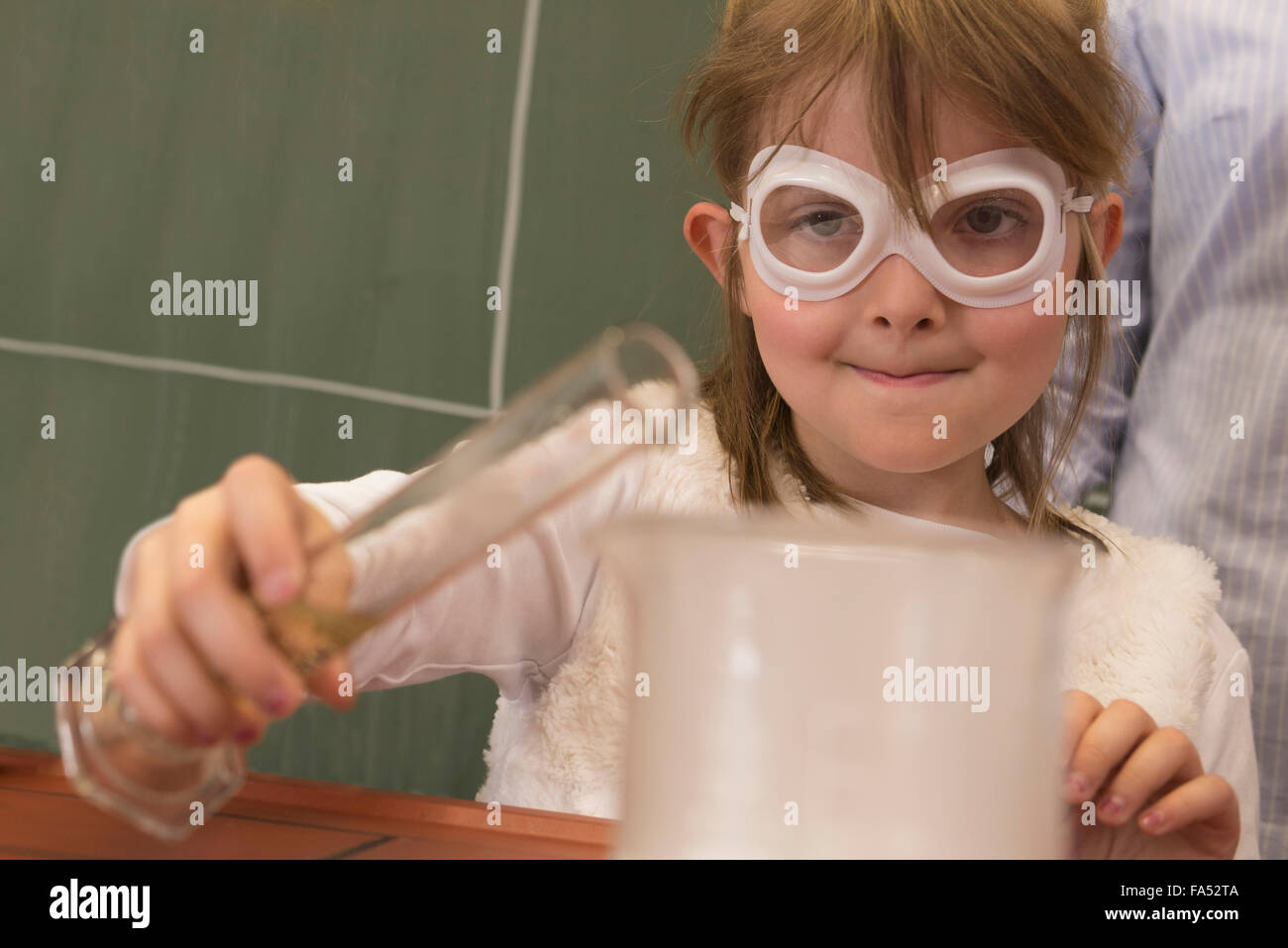 School girl doing experiment with reeky liquid in chemistry class, Fürstenfeldbruck, Bavaria, Germany Stock Photo