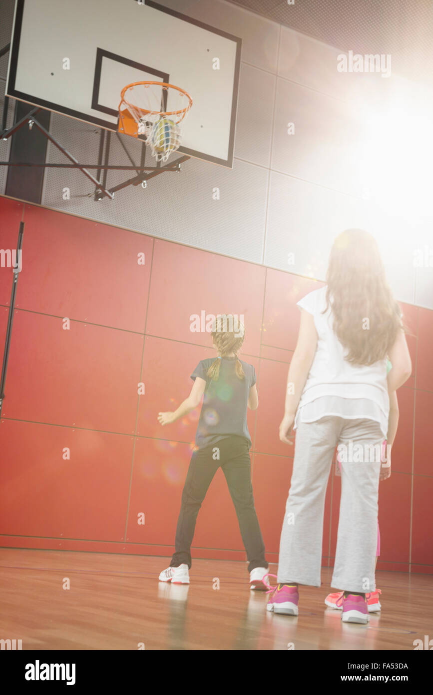 Girls playing basket ball in basketball court, Munich, Bavaria, Germany