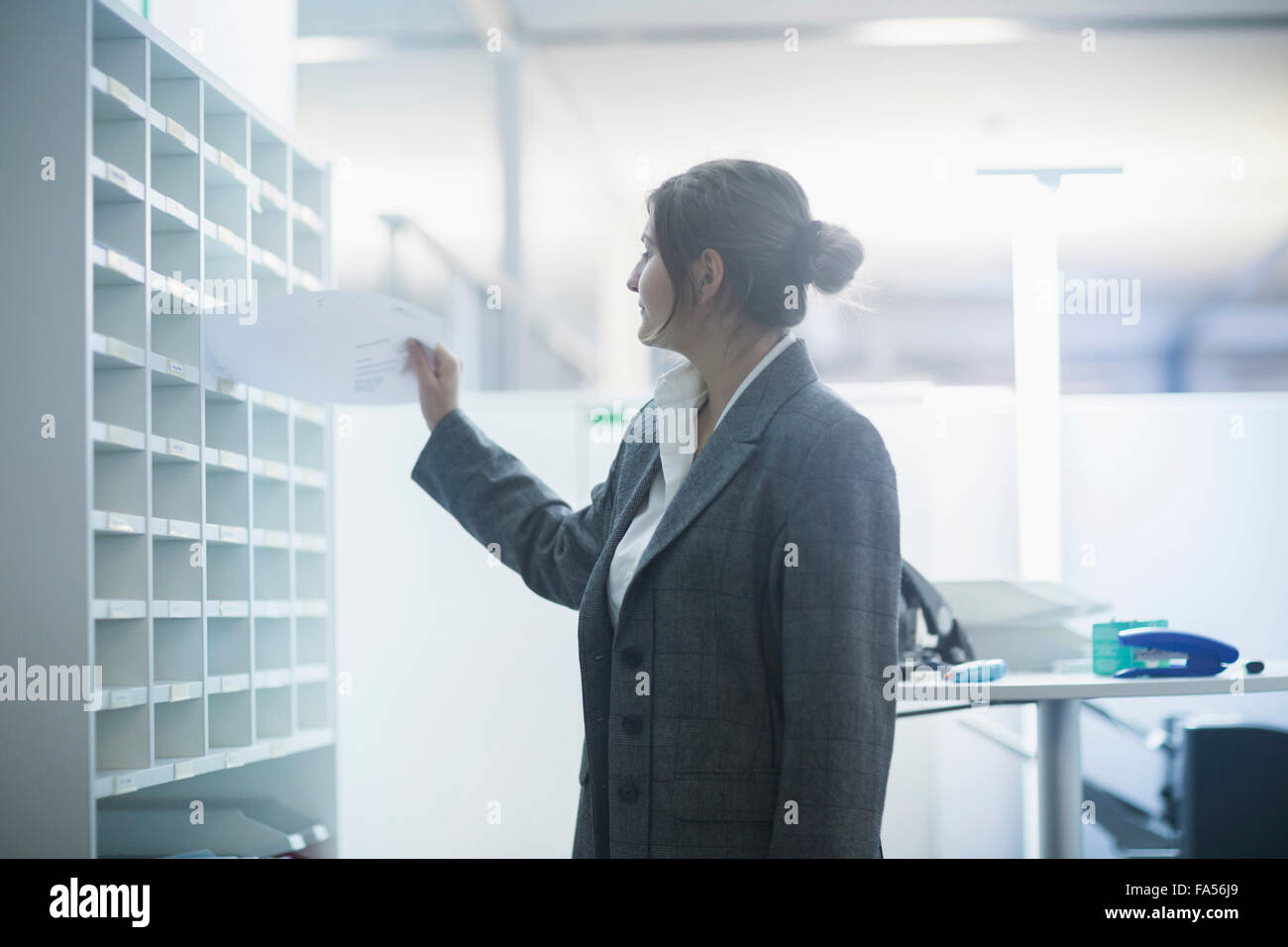 businesswoman sorting papers in filing cabinet, Freiburg Im Breisgau, Baden-Württemberg, Germany Stock Photo