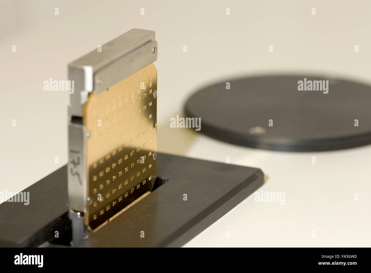 Target plate inserted into MALDI-TOF instrument. Stock Photo