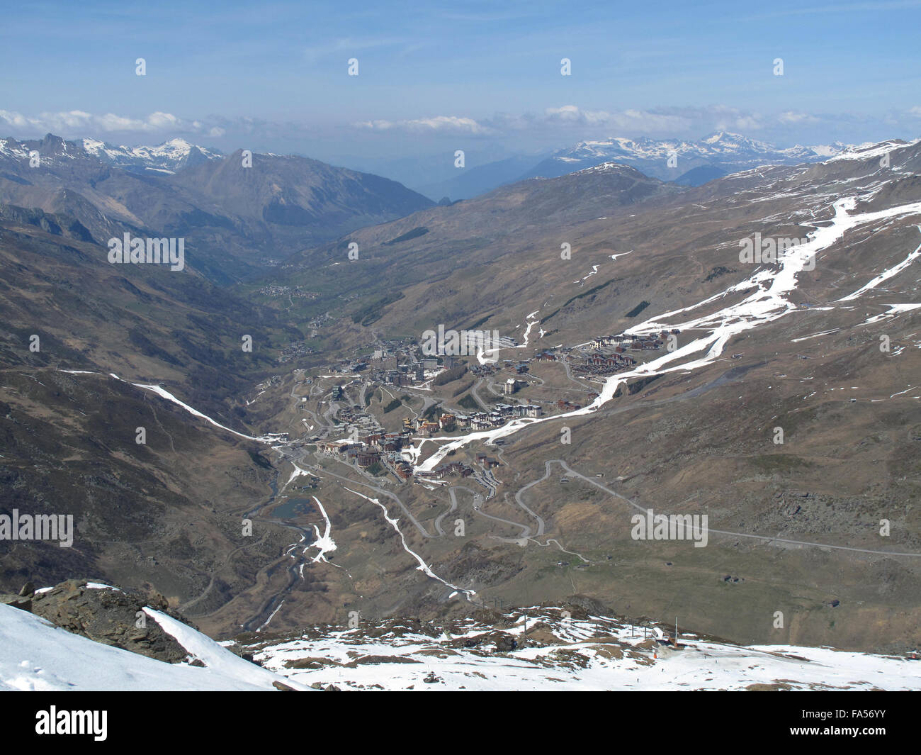 A view of Les menuires in the 3 valleys French alps. Very little snow is left on the slopes Stock Photo