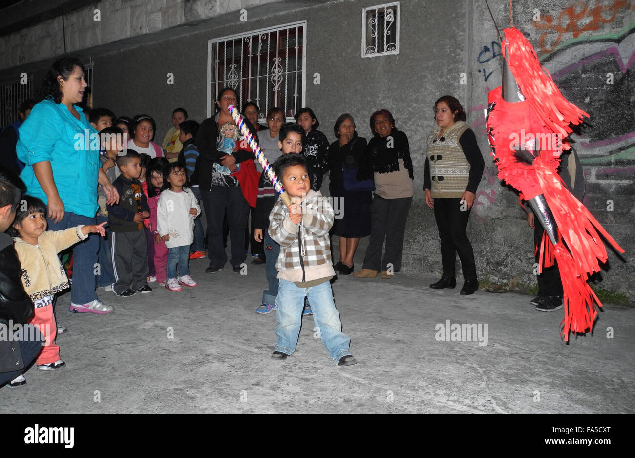 Mexico City, Mexico. 22nd Dec, 2014. Children hitting a pinata in the  Iztacalco district of Mexico City, Mexico, 22 December 2014. The cardboard  pinatas are filled with sweets. When they burst after