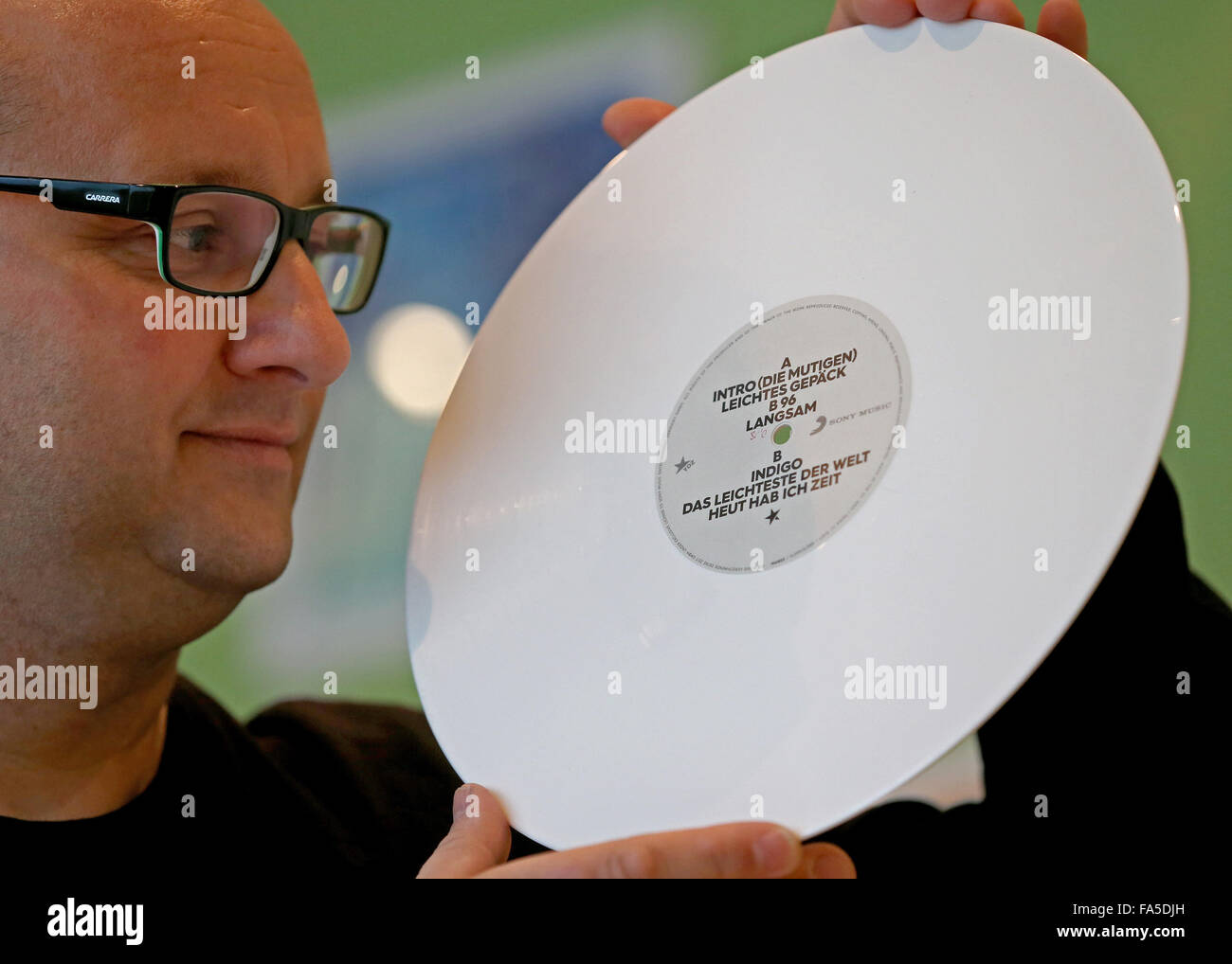 Stollberg, Germany. 3rd Dec, 2015. Carsten Haupt, manager of Celebrate Records, pictured with a white motif record in Stollberg, Germany, 3 December 2015. According to the Bundesverband Musikindustrie (music industry association), the LP record has been making a comeback for several years. In 2014 around 1.8 million records worth 38 million euros were sold, the most since 1992. At Celebrate Records, around 40 employees produce more than 2 million records each year. Around 70 per cent are exported. PHOTO: JAN WOITAS/DPA/Alamy Live News Stock Photo