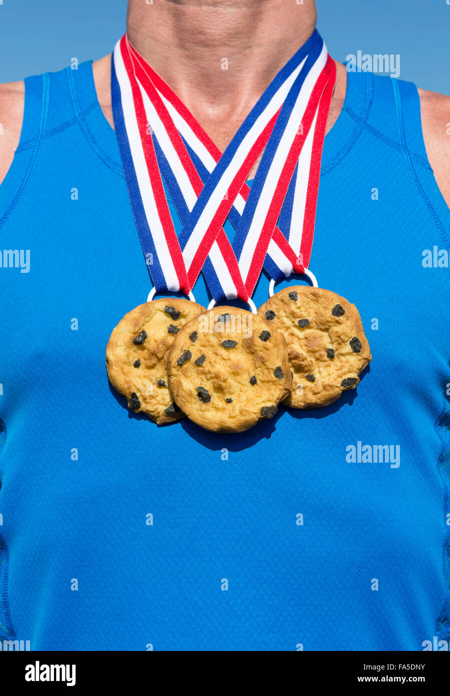 Athlete wearing chocolate chip cookies gold medals standing in front of