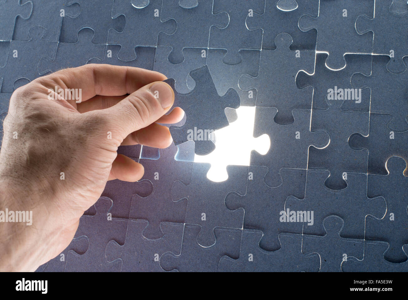 Missing jigsaw puzzle piece with light glow Stock Photo Alamy