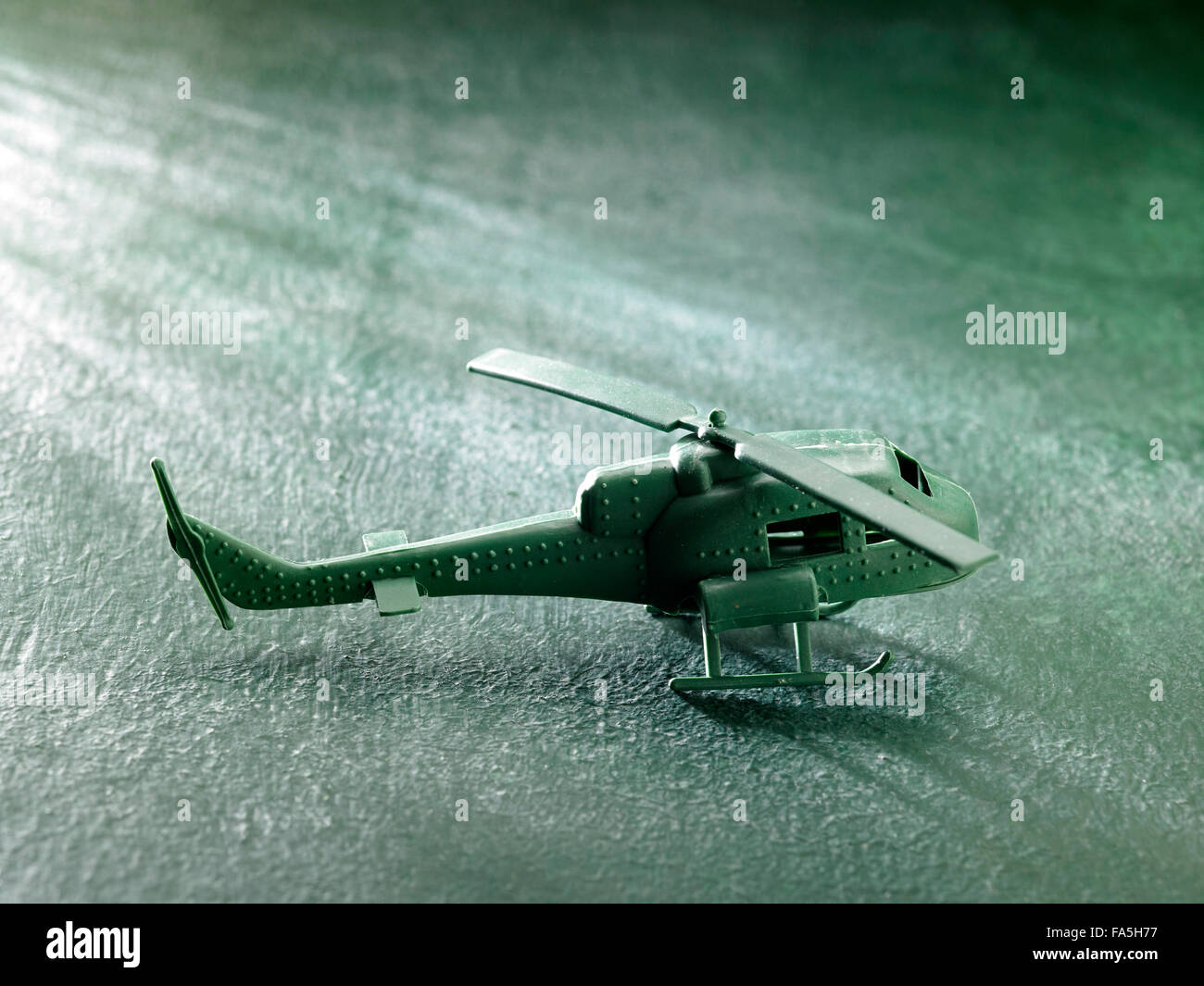 green plastic toy helicopter on the green background Stock Photo