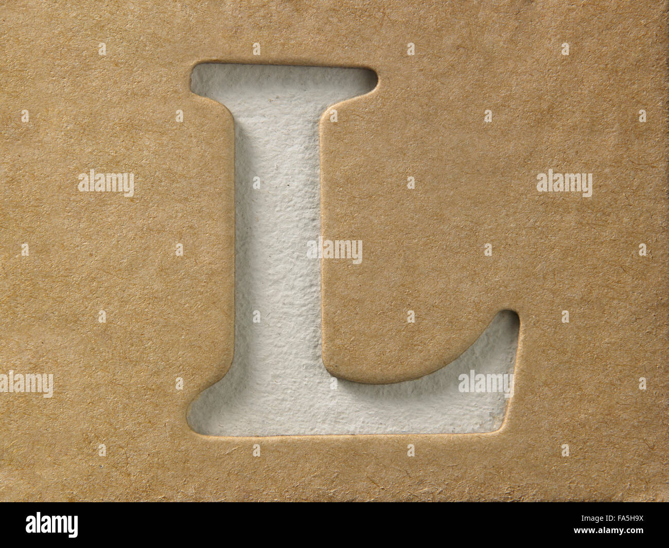 cut out alphabet l on the brown cardboard Stock Photo
