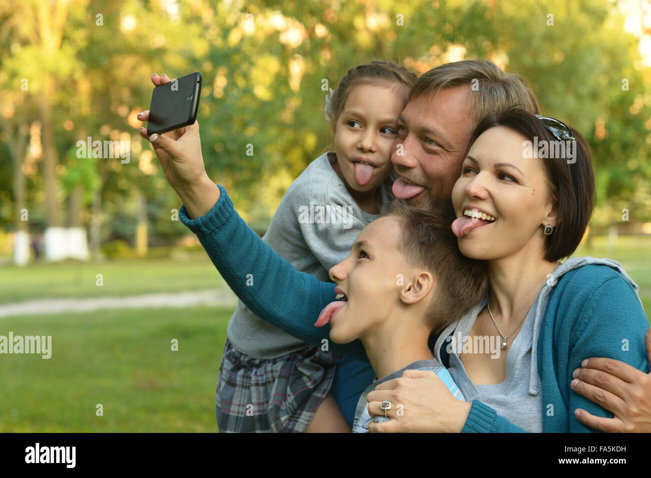Family taking selfie in park Stock Photo - Alamy