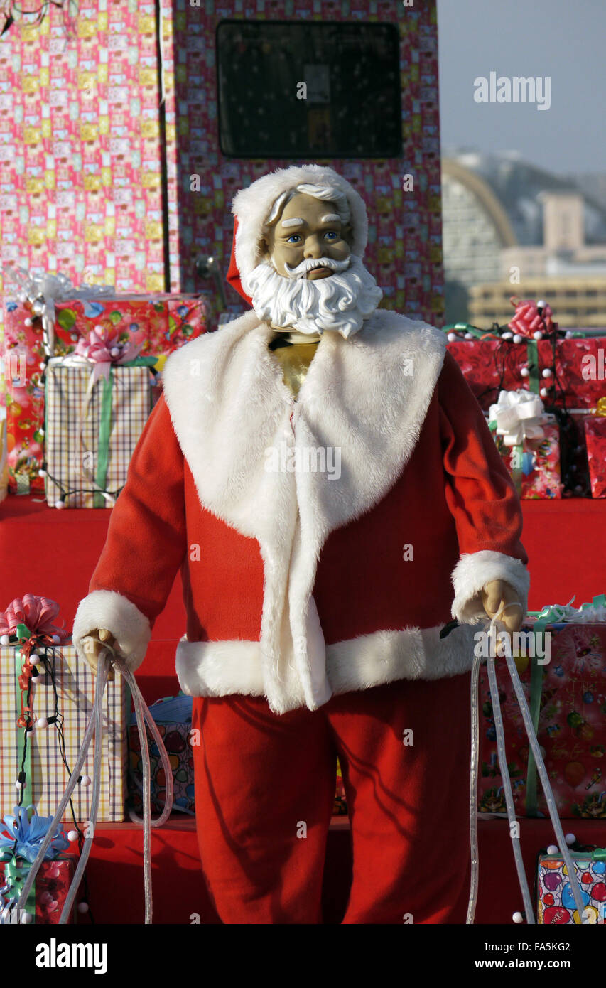 A Santa Claus manikin on his sleigh with a frowning worried apprehensive looking expression pictured outdoors Stock Photo