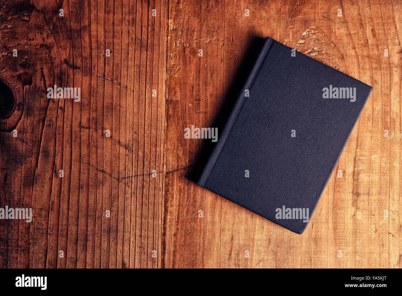 Black notebook on wooden office desk, top view Stock Photo