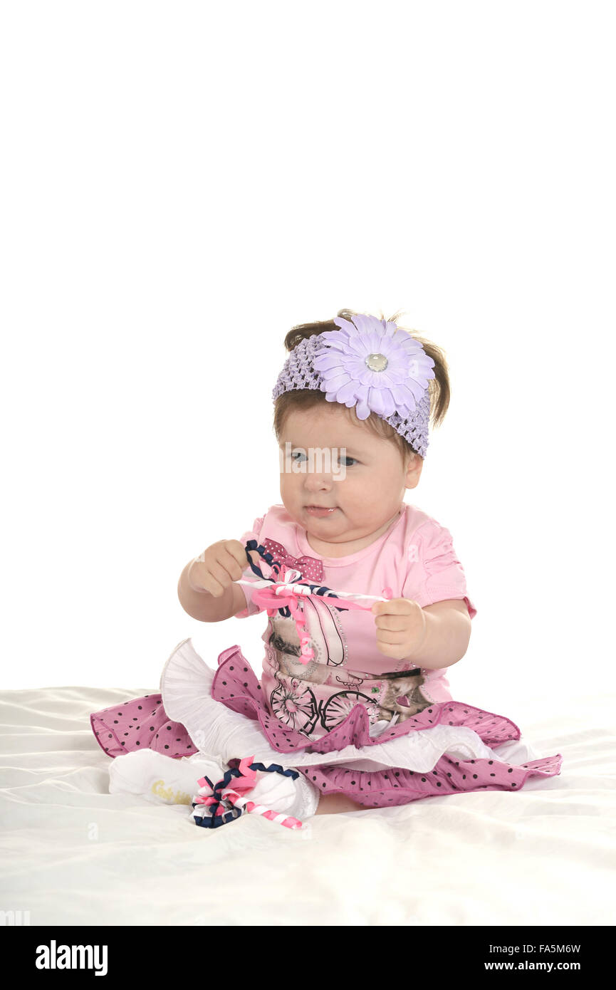 Baby girl on blanket in pink clothes Stock Photo - Alamy