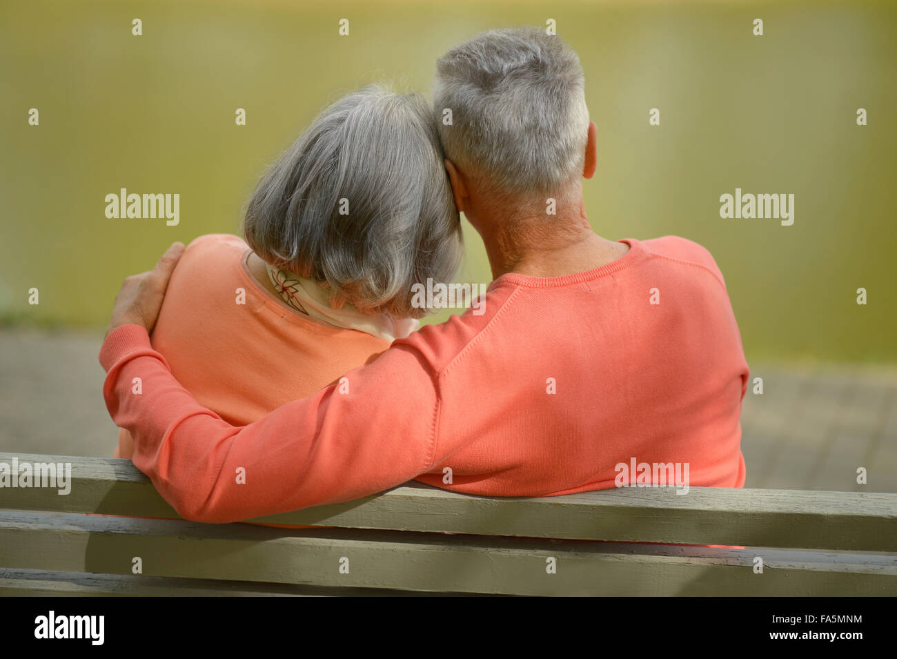 Happy elderly couple sitting on bench Stock Photo - Alamy
