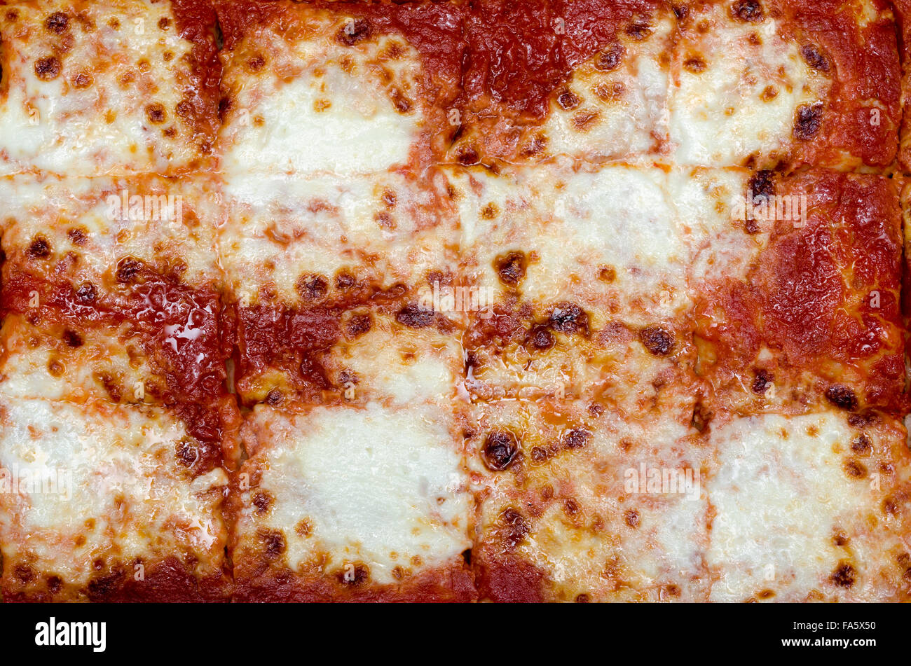 pizza cut into squares with tomato and cheese Stock Photo Alamy