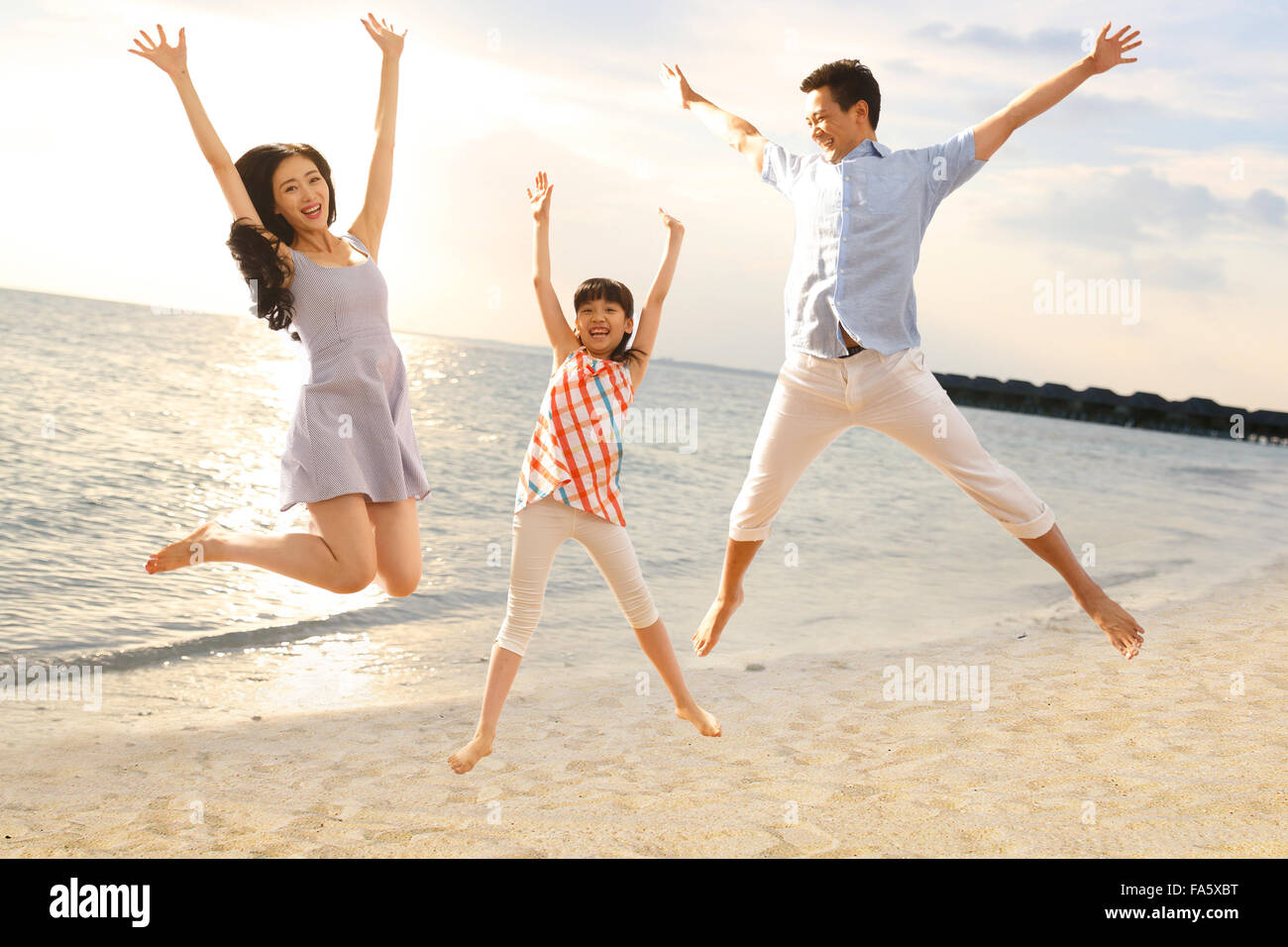 Family jumping on beach Stock Photo Alamy