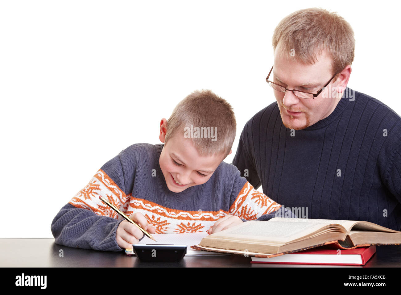 Father helping his son with his homework on a desk Stock Photo - Alamy