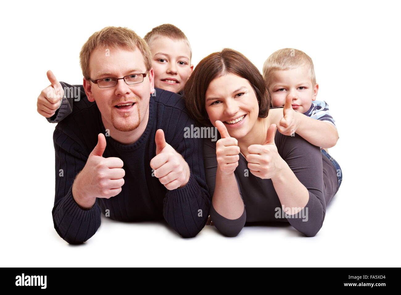 Happy family with two children holding their thumbs up Stock Photo - Alamy