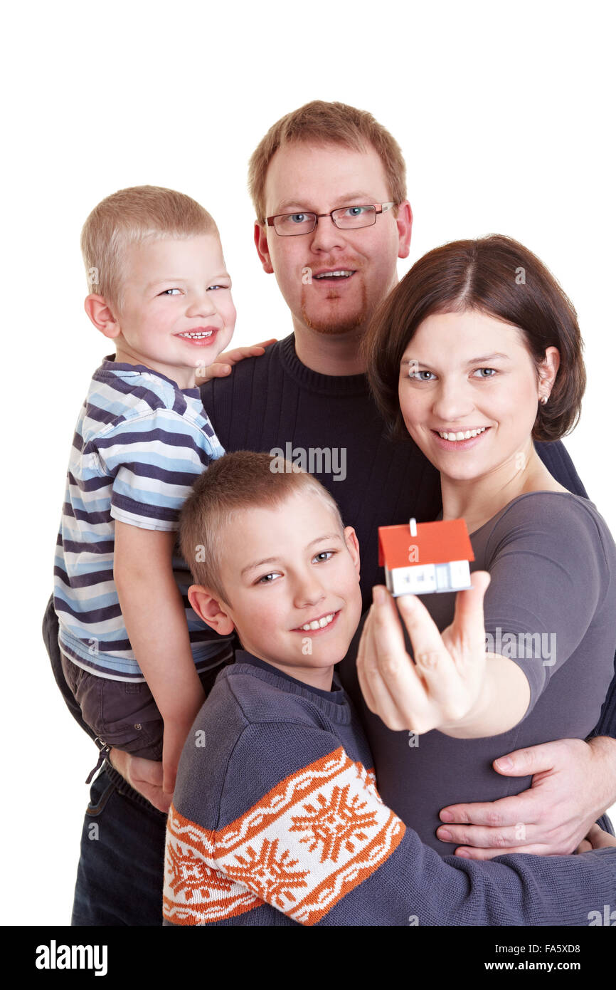 Happy family with two children holding miniature home Stock Photo