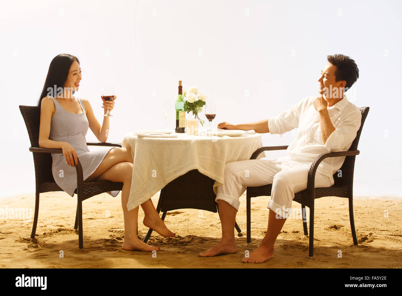Couple having dinner on beach Stock Photo