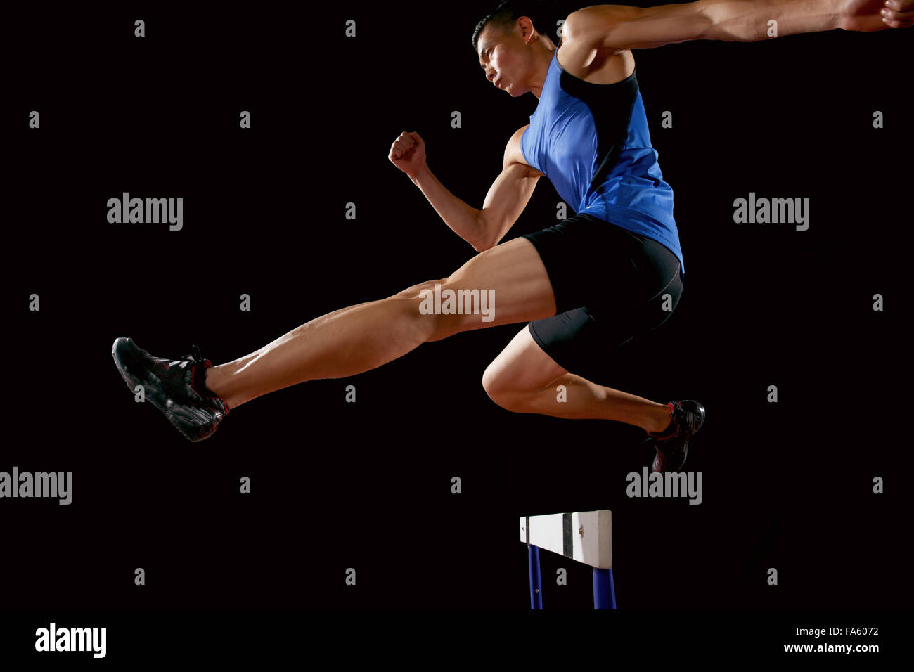 Track and field athletes to do hurdles Stock Photo Alamy