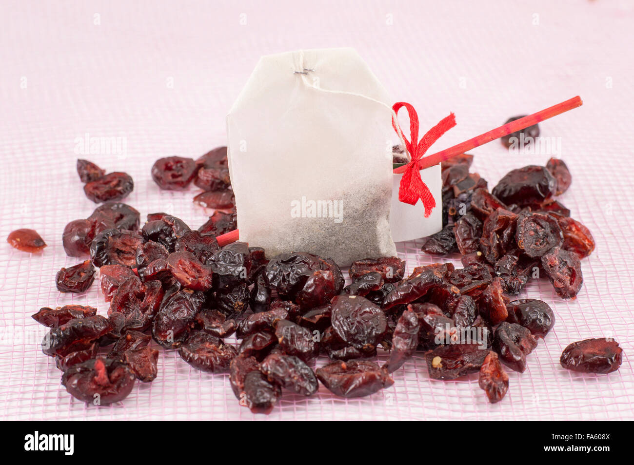 Colorful dried cranberry fruit grains and cranberry tea bag Stock Photo