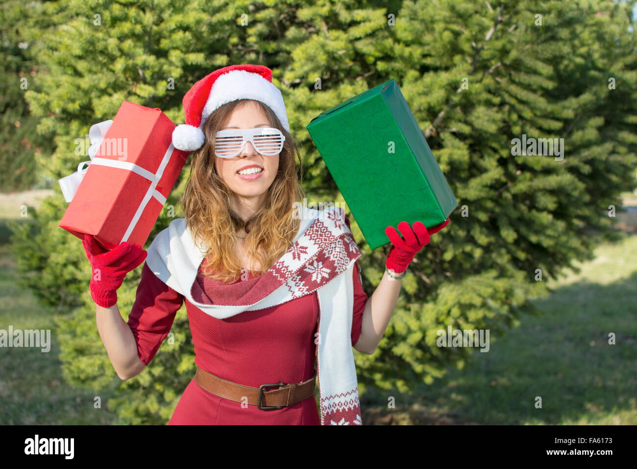 Beautiful Santa Claus girl with Christmas presents Stock Photo