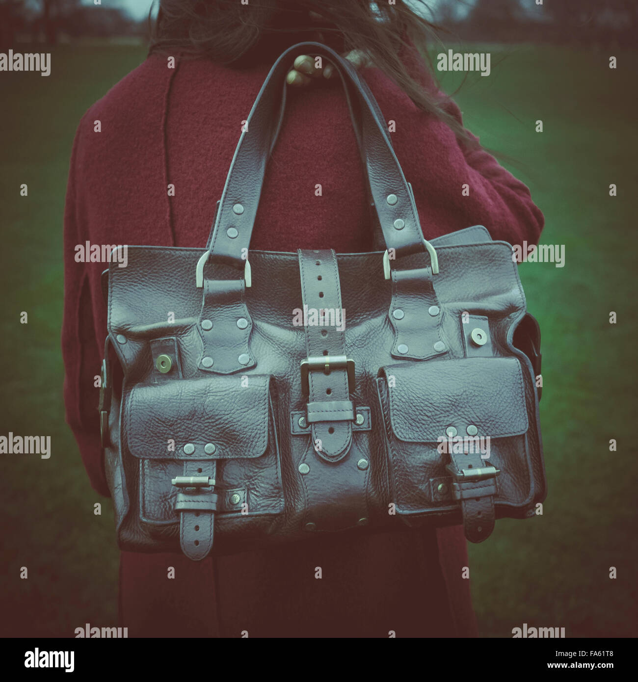 Woman holding Mulberry Roxanne leather handbag over the shoulder with  instagram style filter effect Stock Photo - Alamy