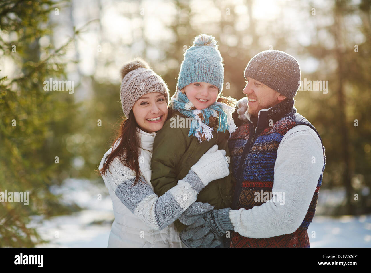 Happy family spending weekend in winter park Stock Photo