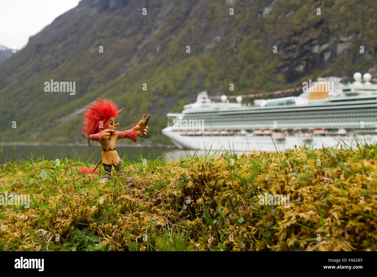 Troll standing on a bank firing a catapult at the P&O cruise ship Ventura. Stock Photo