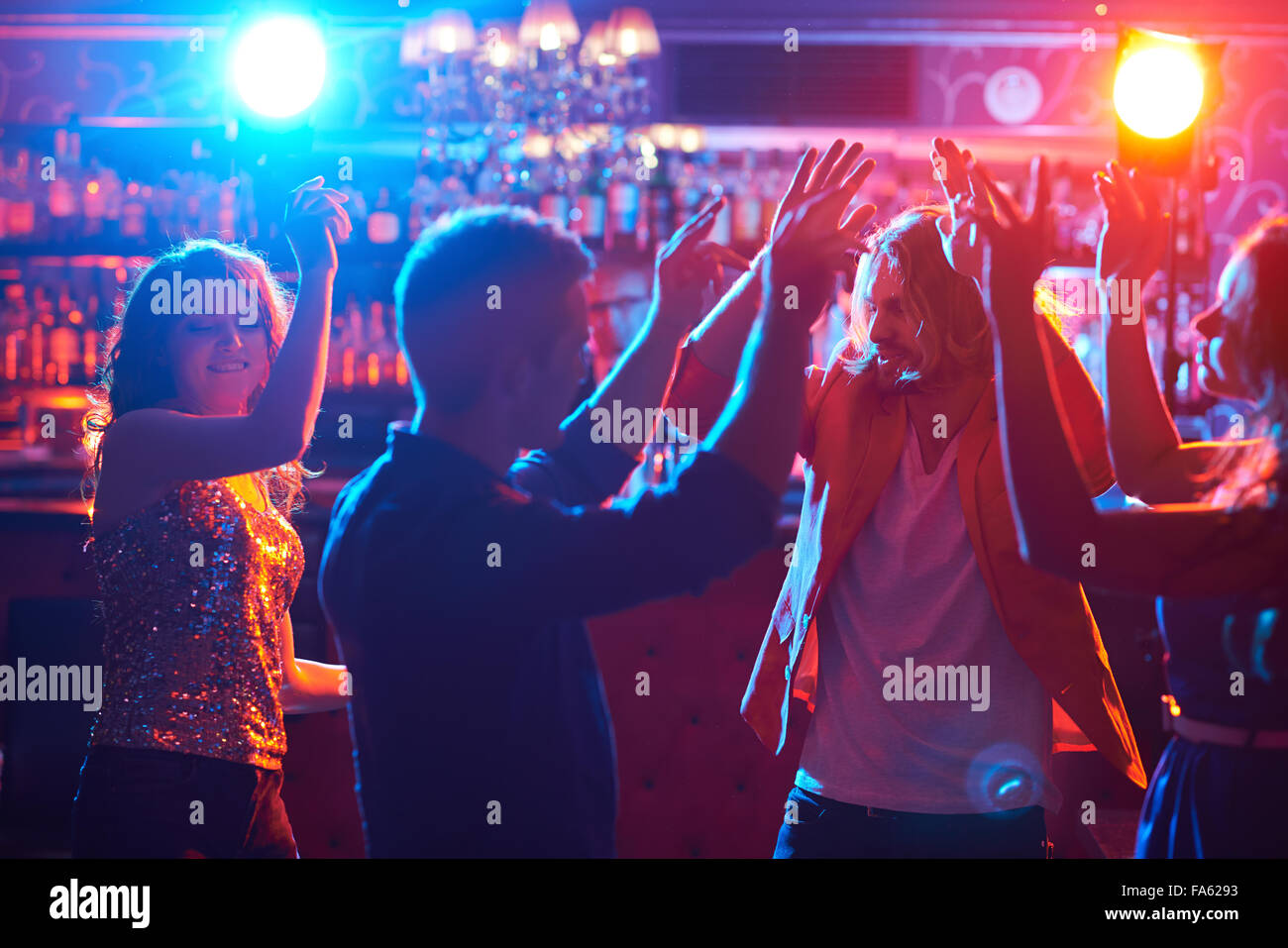 Happy friends dancing together in club Stock Photo - Alamy