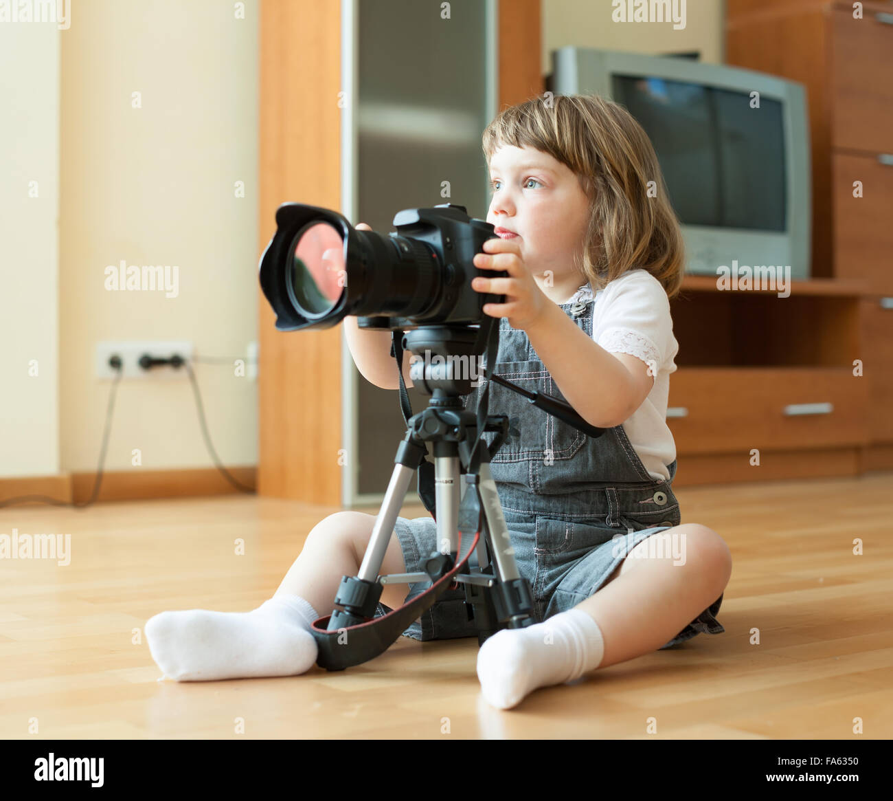 girl takes photo with camera and tripod in home Stock Photo Alamy